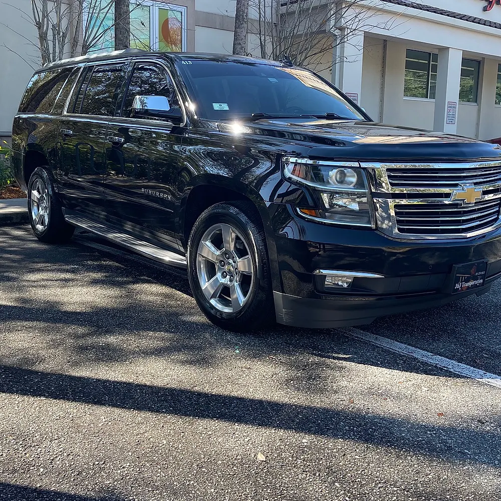 Front three-quarter view of the black Chevrolet Suburban LTZ with chrome grille