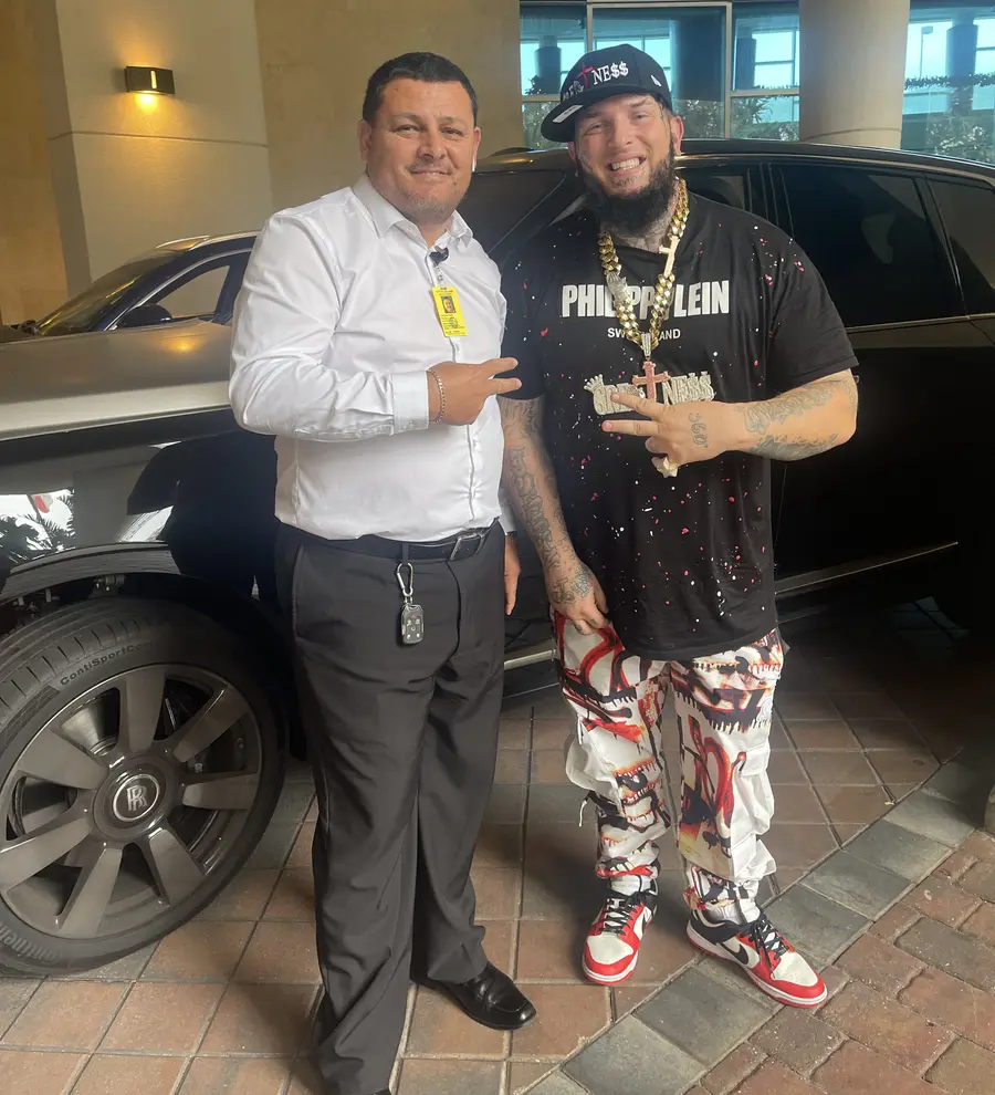 Chauffeur with a VIP client outside a luxury hotel