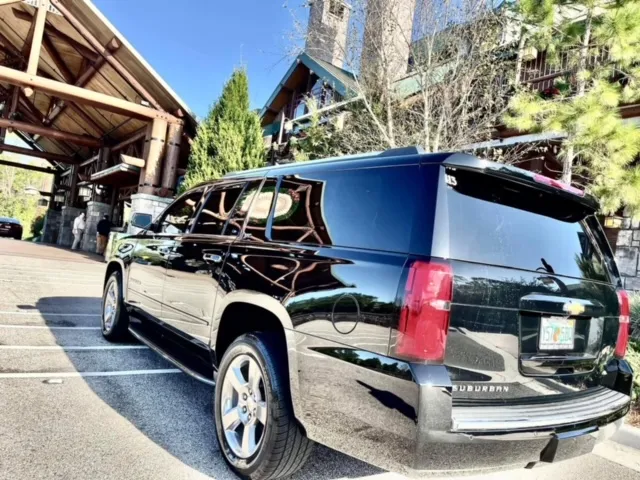 Black Suburban at a resort porte-cochère
